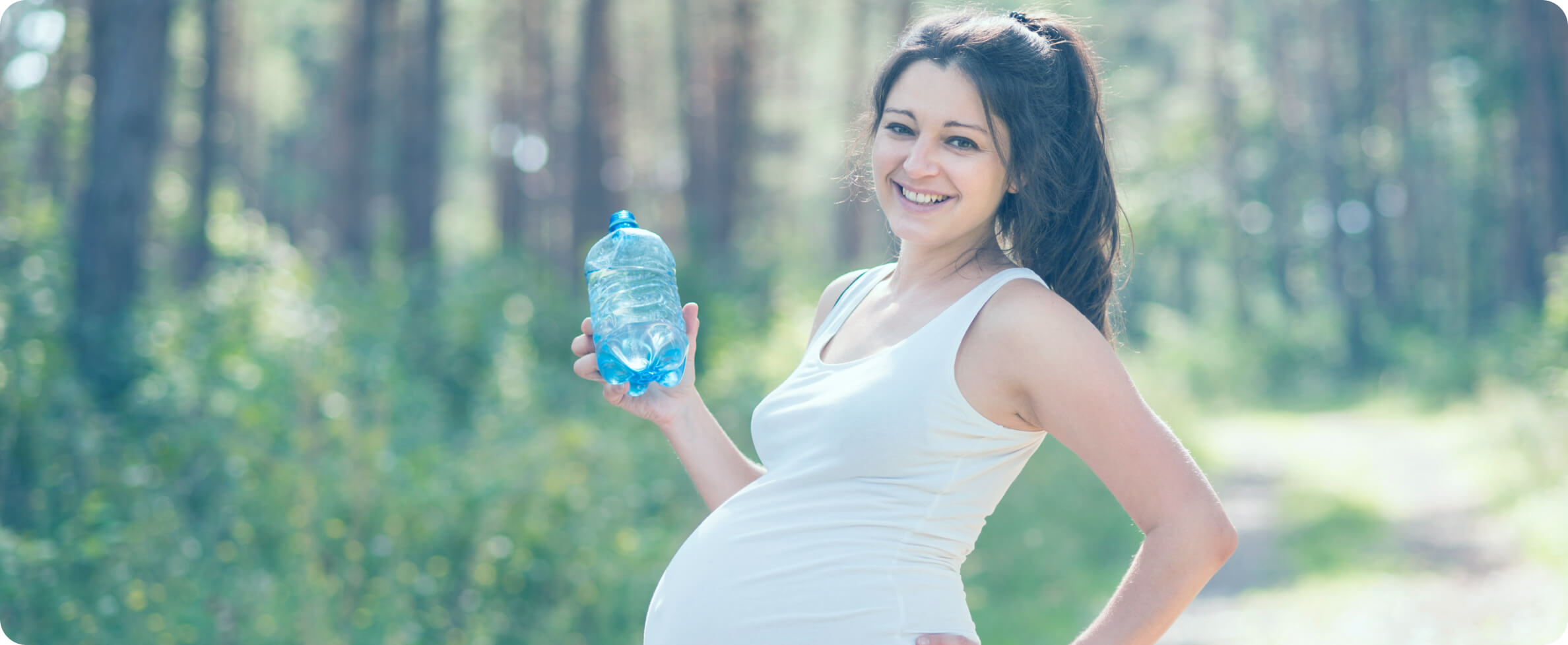 pregnant woman holding a water bottle