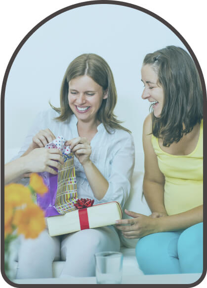 woman opening a gift with her friend