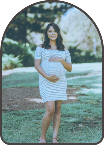 woman posing for a photo with her pregnant belly