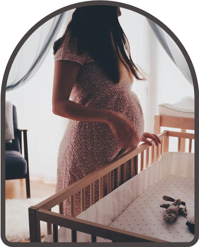 pregnant mother preparing a child's crib